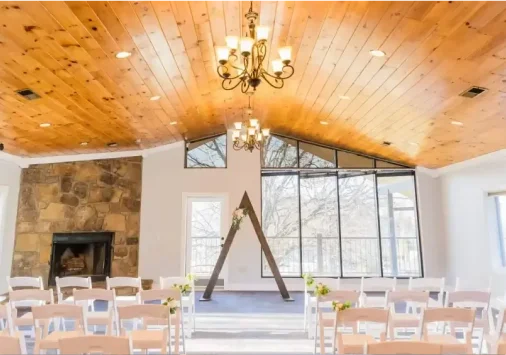 Upper level of the Tremont event lodge with vaulted wood ceiling and stone fireplace